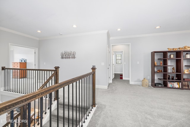 hallway featuring baseboards, recessed lighting, crown molding, carpet flooring, and an upstairs landing