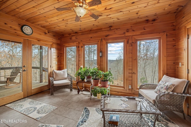 sunroom featuring french doors, wooden ceiling, and a ceiling fan