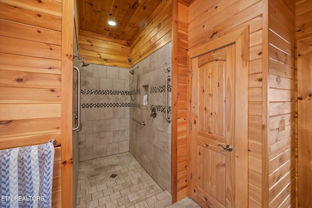 bathroom featuring a shower stall, wooden walls, and wooden ceiling