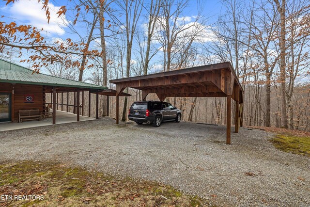 view of vehicle parking with gravel driveway