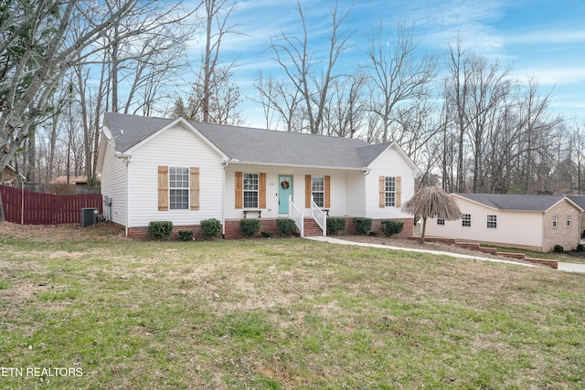 ranch-style home featuring central AC, a shingled roof, a front lawn, and fence