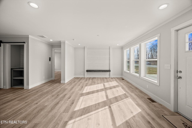 1620 Anna Maria Ln, Cookeville, TN 38501 - unfurnished living room featuring plenty of natural light, a barn door, crown molding, recessed lighting, and baseboards