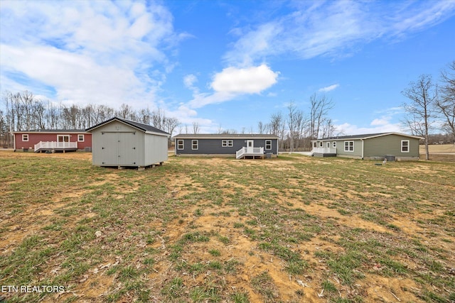 1620 Anna Maria Ln, Cookeville, TN 38501 - view of grassy yard with a storage unit, an outdoor structure, and a deck