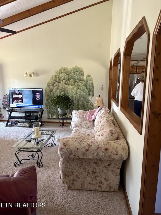 carpeted living area featuring baseboards