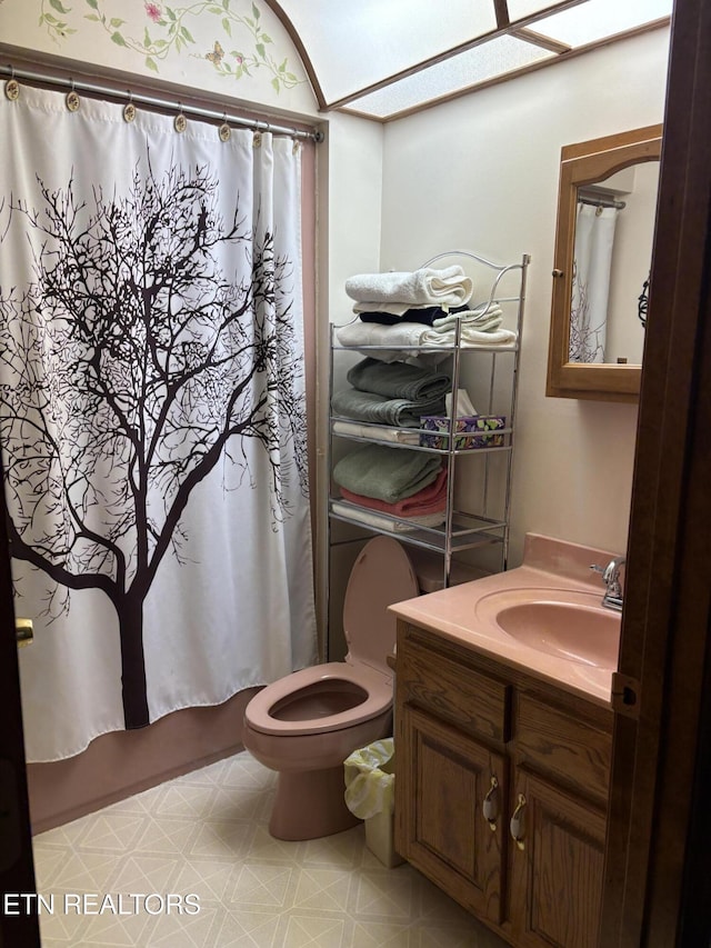 bathroom featuring vanity, tile patterned floors, shower / tub combo, and toilet