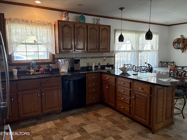 kitchen with a sink, black dishwasher, dark countertops, a peninsula, and a breakfast bar area