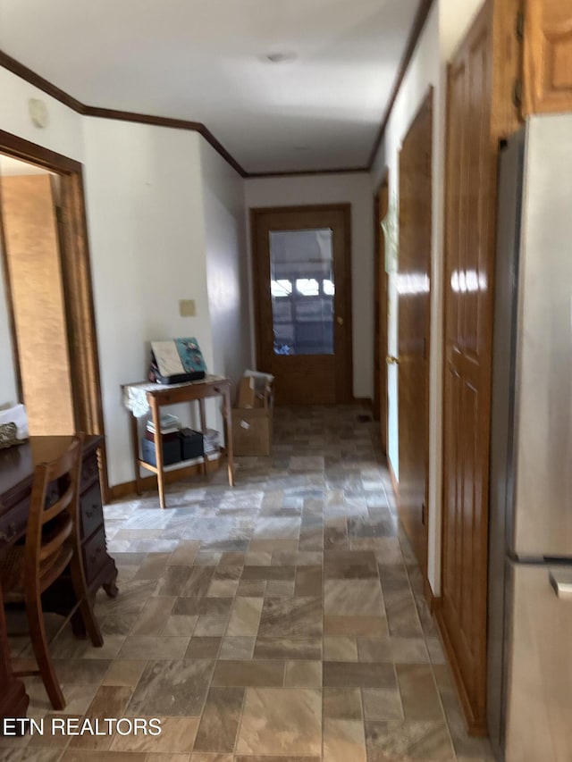 corridor featuring stone finish flooring and ornamental molding