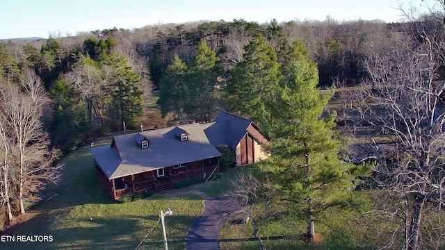 aerial view featuring a wooded view