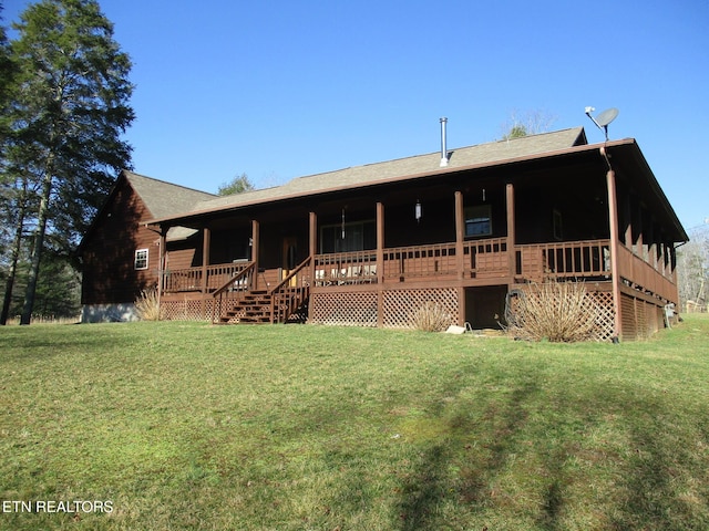 rear view of property with a yard and a porch