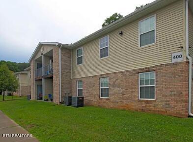 view of side of home with a yard and brick siding