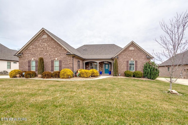 view of front facade with a front lawn and brick siding