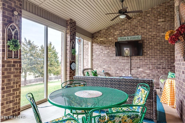 sunroom / solarium with ceiling fan, wooden ceiling, and lofted ceiling