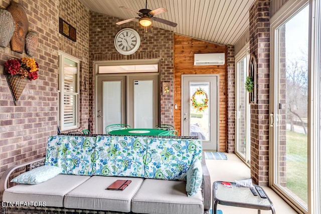 sunroom / solarium featuring an AC wall unit, a ceiling fan, and vaulted ceiling