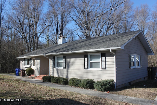 view of front of property featuring roof with shingles and a chimney