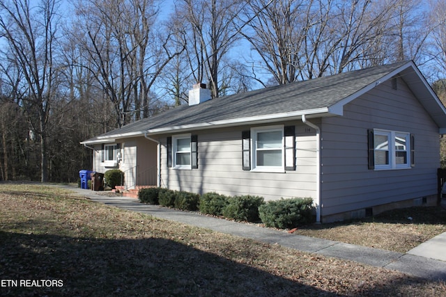 view of side of property with a chimney