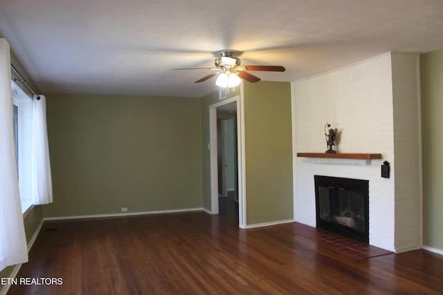 unfurnished living room featuring a brick fireplace, wood finished floors, and baseboards