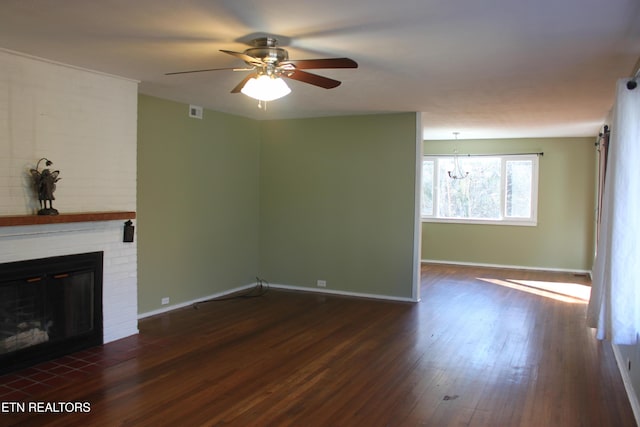 unfurnished living room with visible vents, ceiling fan, baseboards, a fireplace, and wood finished floors