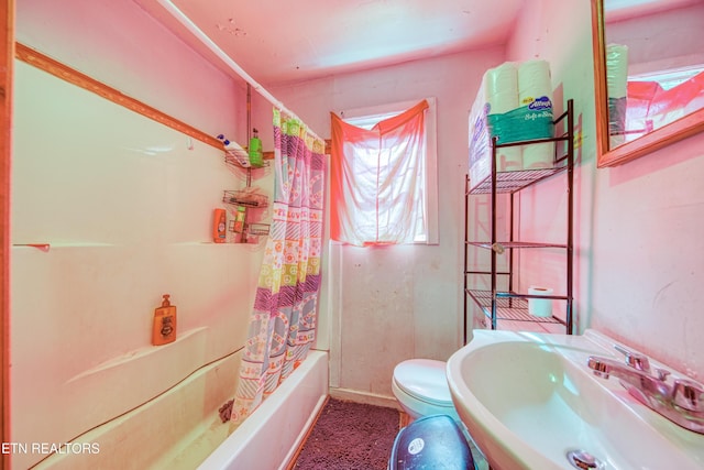 bathroom with a sink, toilet, and shower / tub combo