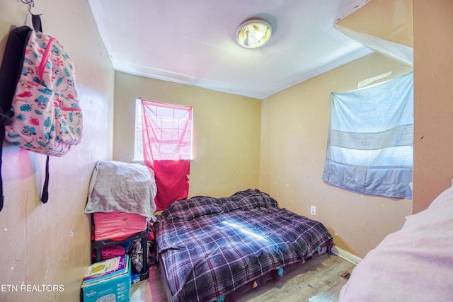 bedroom with wood finished floors and baseboards