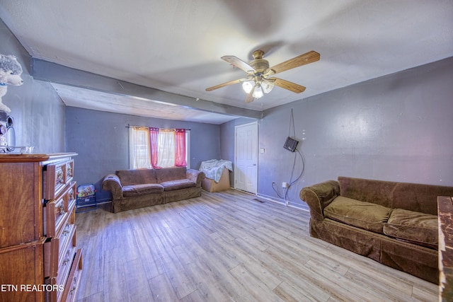 living area featuring wood finished floors and ceiling fan