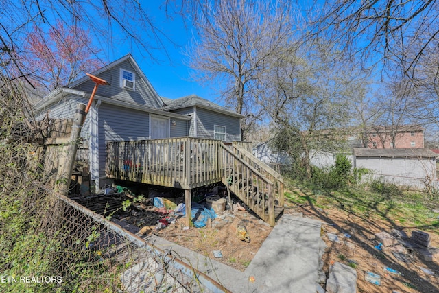 rear view of property with a deck and stairs