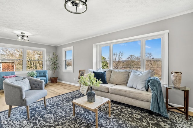 living area featuring plenty of natural light, wood finished floors, and ornamental molding