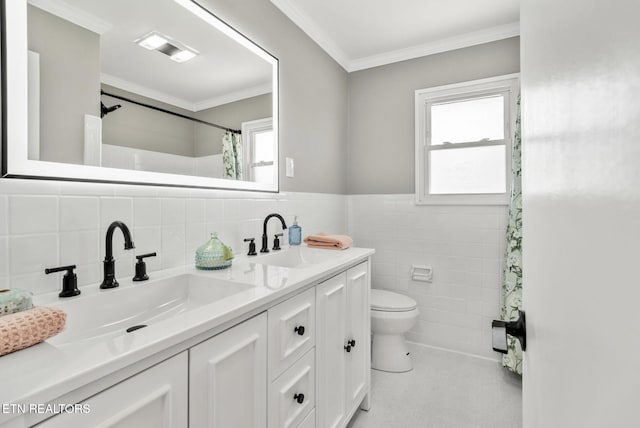 bathroom featuring toilet, tile walls, ornamental molding, and a sink