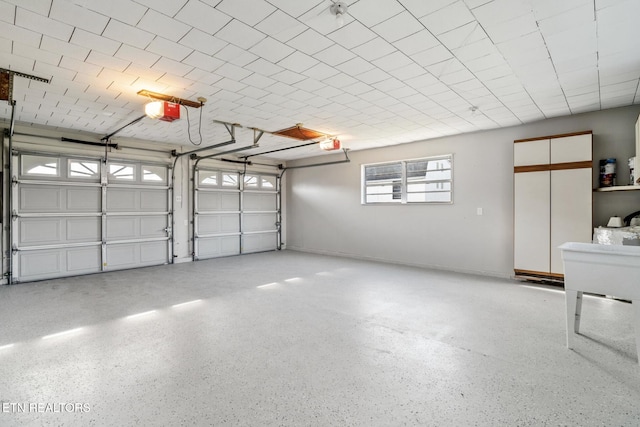 garage featuring baseboards and a garage door opener