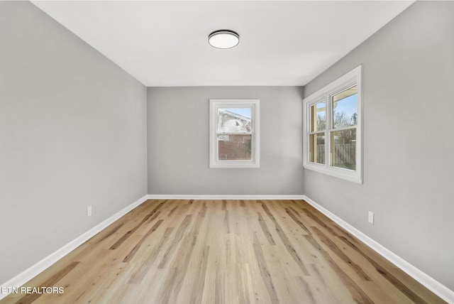 empty room featuring baseboards and wood finished floors