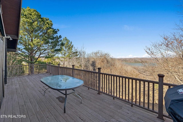 wooden deck featuring a grill