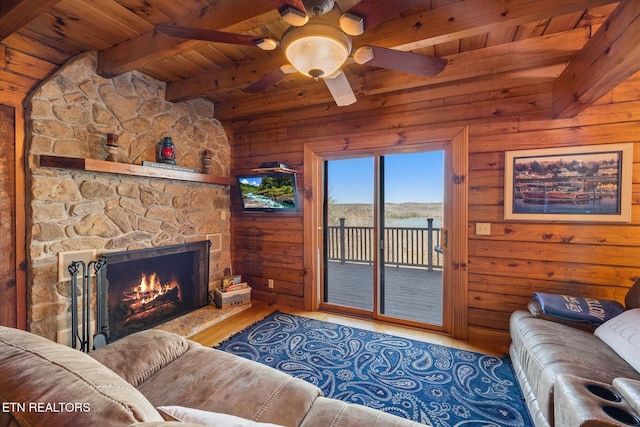 living room with wood finished floors, a fireplace, wood ceiling, wood walls, and beamed ceiling