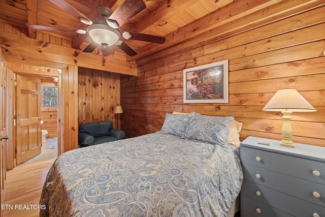 bedroom featuring wood ceiling, beamed ceiling, wood finished floors, and wood walls