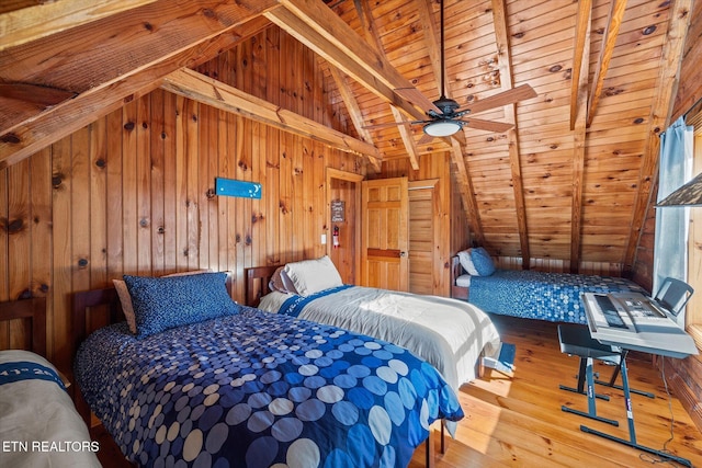 bedroom with wooden walls, wooden ceiling, lofted ceiling with beams, and wood finished floors