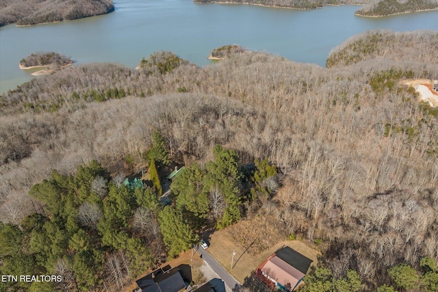 aerial view with a forest view and a water view