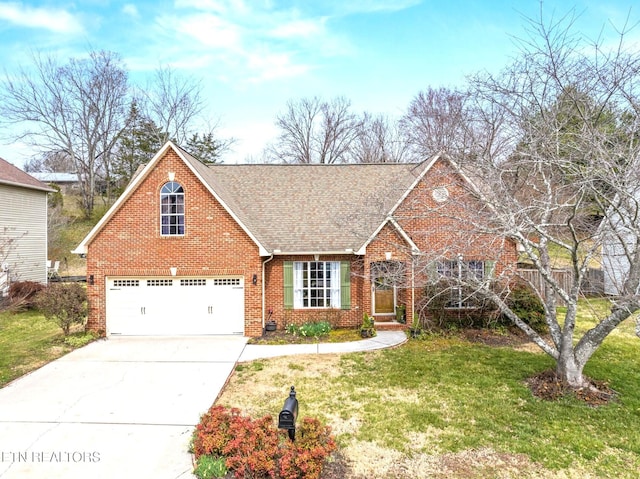 traditional-style home with a front lawn, concrete driveway, a shingled roof, a garage, and brick siding