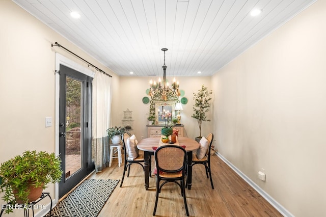 dining room with recessed lighting, light wood-type flooring, a chandelier, and baseboards