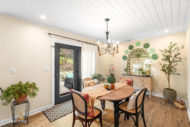 dining space featuring wood ceiling, a notable chandelier, baseboards, and light wood-type flooring