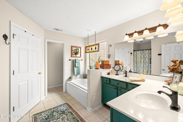 full bathroom with tile patterned floors, a bath, visible vents, and a sink