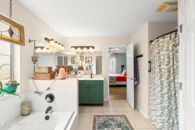 full bathroom with tile patterned flooring, visible vents, connected bathroom, a garden tub, and vanity