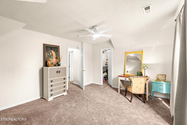 sitting room featuring visible vents, baseboards, carpet, a textured ceiling, and a ceiling fan