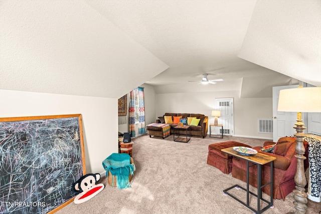 carpeted living area with baseboards, visible vents, a ceiling fan, and lofted ceiling