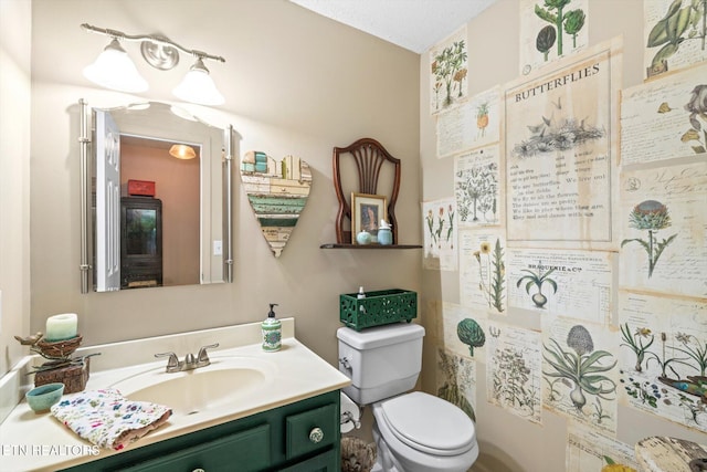 half bathroom featuring toilet and vanity