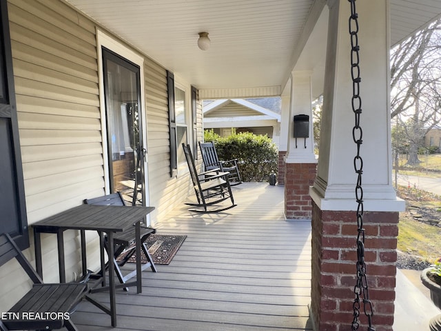 wooden terrace featuring a porch