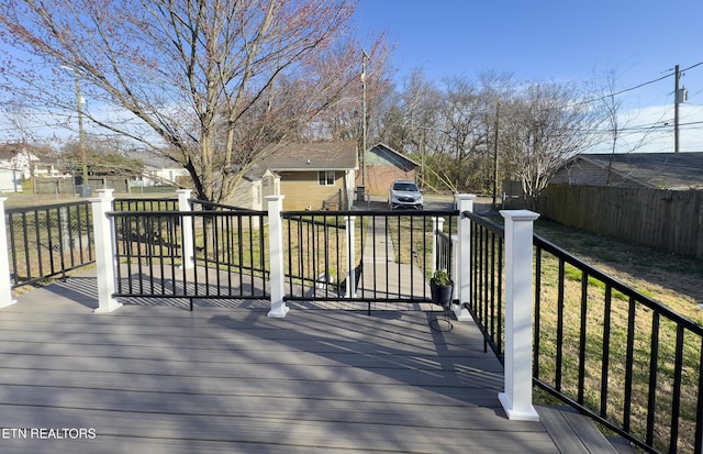 wooden deck featuring an outdoor structure and fence