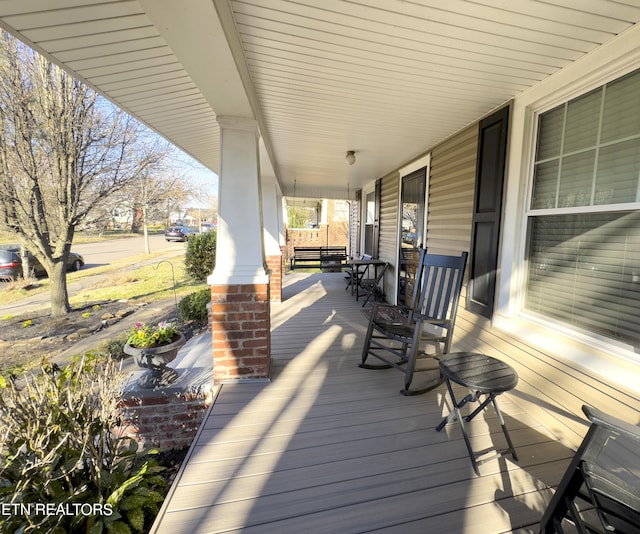 wooden terrace featuring a porch