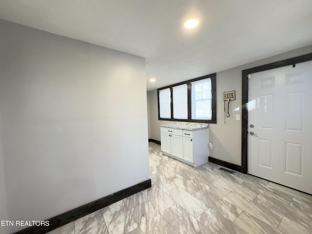 interior space with visible vents, baseboards, and marble finish floor