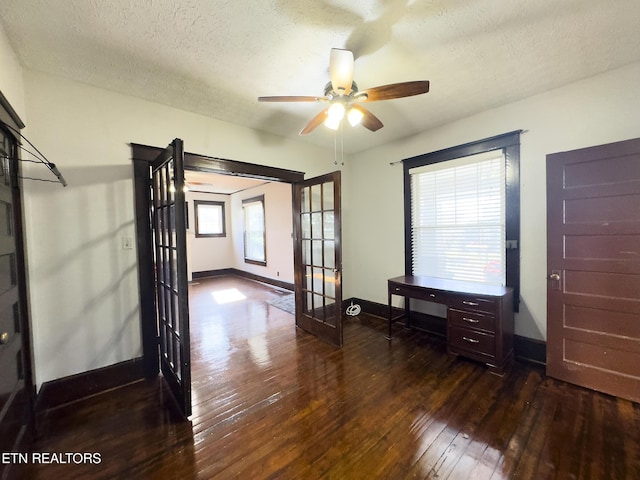 interior space featuring ceiling fan, baseboards, french doors, hardwood / wood-style flooring, and a textured ceiling