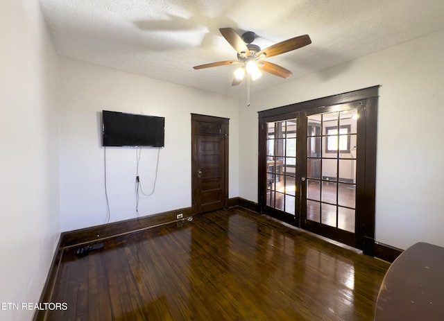 interior space featuring a ceiling fan, a textured ceiling, hardwood / wood-style floors, french doors, and baseboards