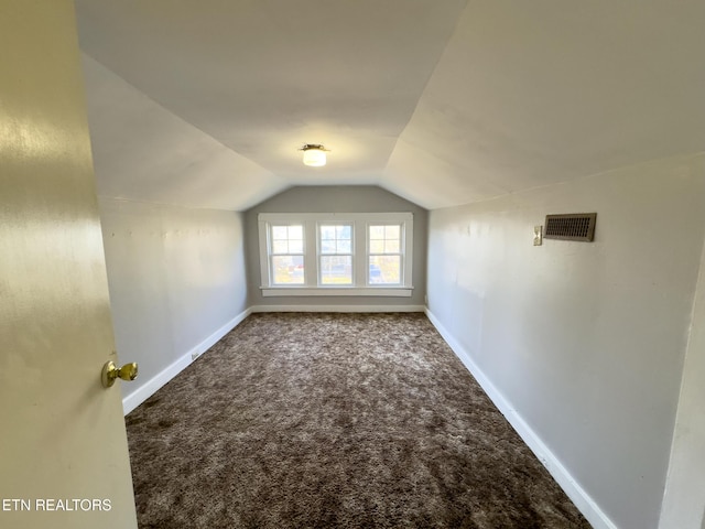 bonus room featuring vaulted ceiling, visible vents, baseboards, and carpet floors