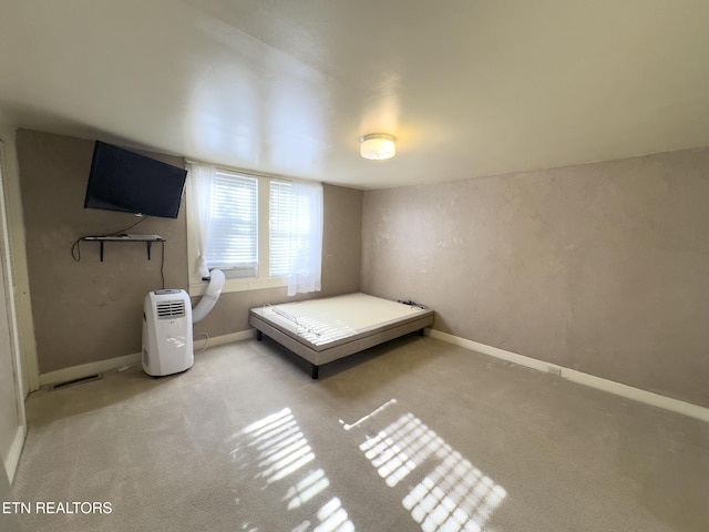 unfurnished bedroom featuring carpet and baseboards